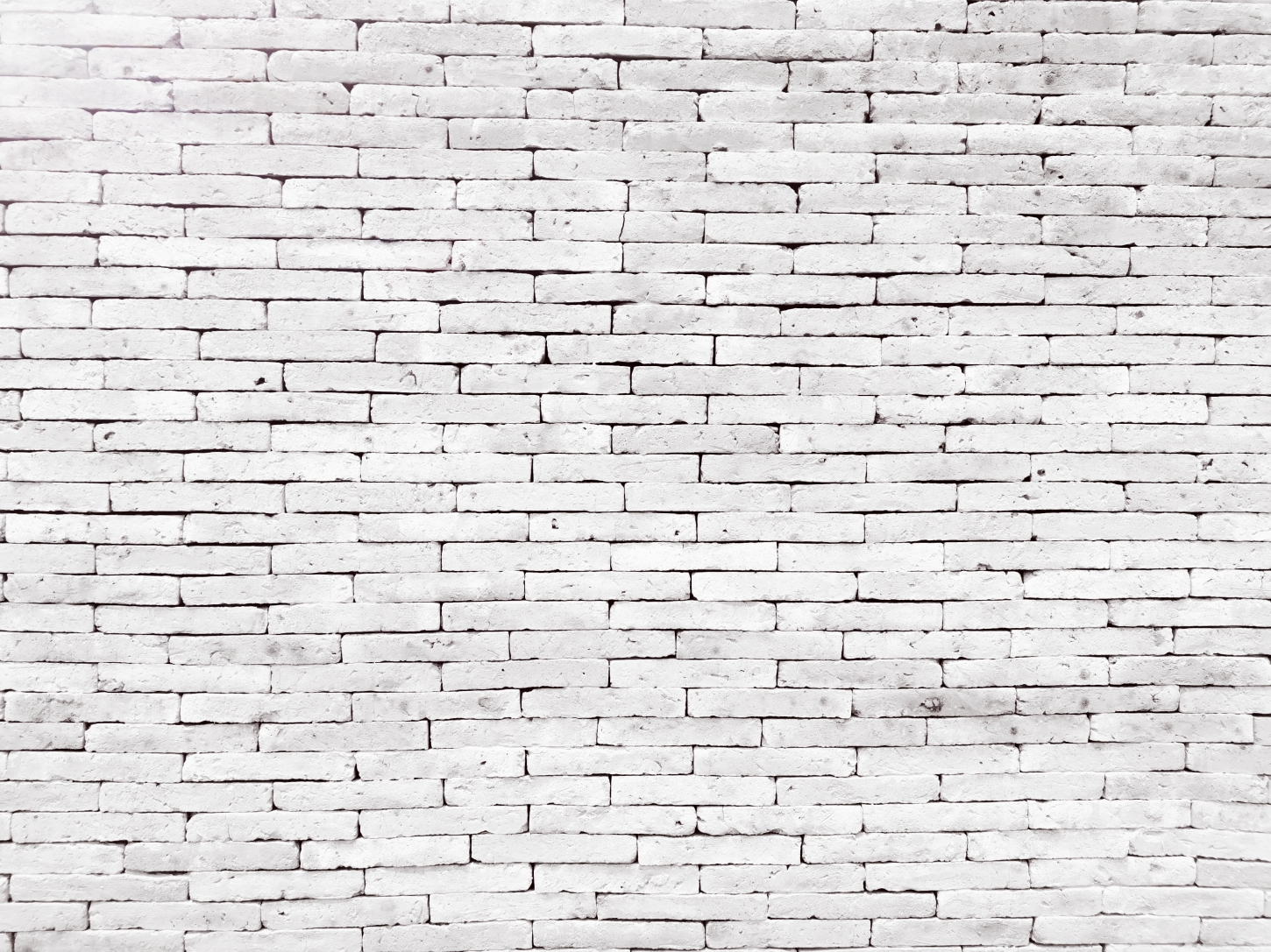 Close-up van een witte bakstenen muur.